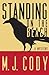 Standing on the Beach by M.J. Cody