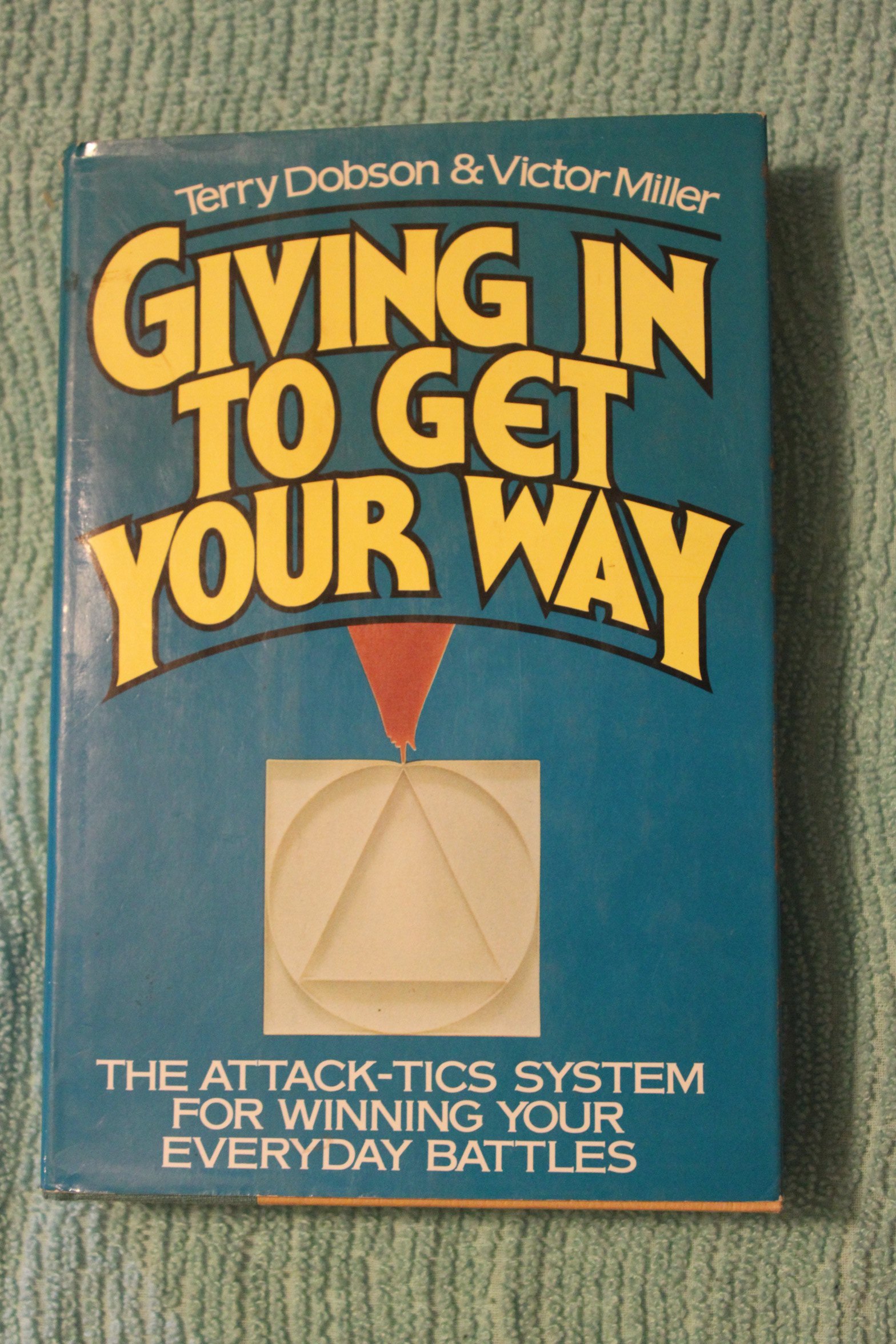 Giving in to get your way: The attack-tics system for winning your everyday battles (Paperback)