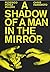 A shadow of a man in the mirror