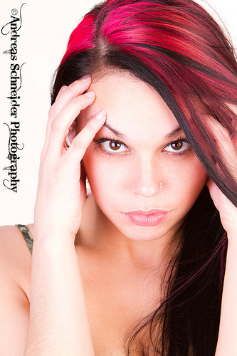 Intense beauty, Headshot of dynamic model with intense eyes and awesome streaked red hair.