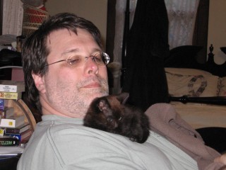 my husband with little Valeria. Her training as a writer's cat continues!