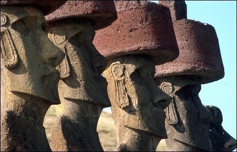 The ancient statues have giant red hats (BBC)