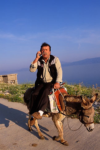 3-701-39 stock photo of Greece, Hydra, Man on donkey with cell phone