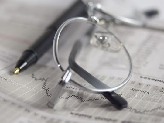 Eyeglasses, newspaper and pen