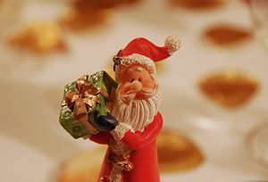 CLose-up of a Santa Claus figurine bearing a p...