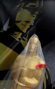 An Oscars statue is shrouded in plastic as hea...