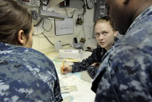 110405-N-5716H-370 PACIFIC OCEAN (April 5, 2011) Quartermaster 3rd Class Valerie Slaughter, center, trains Quartermaster Seaman Tailor Guy and Quartermaster Seaman Jarrin Davis on chart reading in the chart room aboard the amphibious transport dock ship USS Tortuga (LSD 46). Tortuga is operating in the U.S. 7th Fleet area of responsibility supporting Operation Tomodachi. (U.S. Navy photo by Mass Communication Specialist 1st Class Josh Huebner/Released)