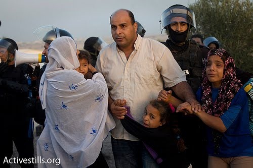 Photo by Oren Ziv of the initial expulsion and destruction of Al Arakib, a Bedouin village in the Negev that the state of Israel has destroyed 21 times in the past year
