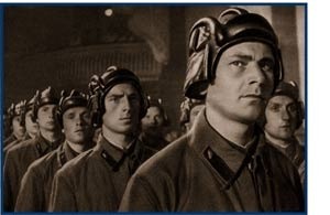 Picture of c troop, in funny hats. Guy in front looks uncertain.