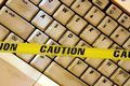 939470-concept-of-warning-of-the-bad-things-online-caution-tape-acrossed-a-dirty-laptop-keyboard