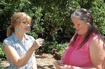 Spring Warren, left, and Kami McBride discuss the medicinal uses of a common