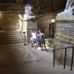 some attendees at the landing of the great lion-flanked staircase