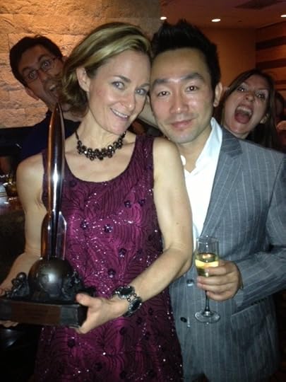 Here is Galen Dara and Wes Chu posing with her Hugo, and getting photobombed by Sandra Wickham and a gentleman I did not meet.