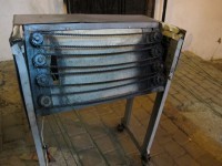 The machine with which the brocade for djellabas is made. You can see the threads coming off--it's like a mechanical braider.