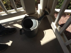 a watering can on the front porch