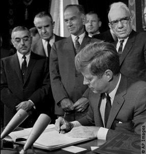 President John F. Kennedy signs the Limited Test Ban Treaty in October 1963. 