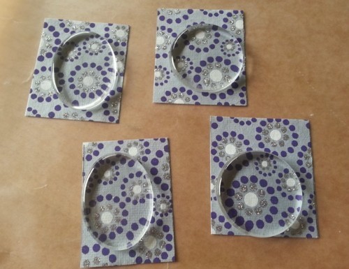 glass pendant tiles on recycled paper