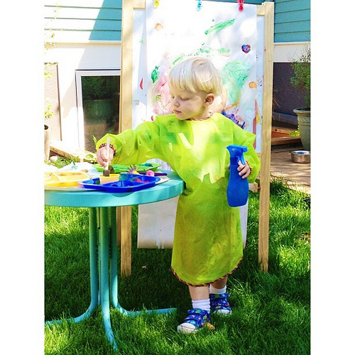 Round two of painting in the backyard. He has obviously discovered one of mama's favorite painting tools in the sprayer! Next up: the brayer. #sprayerandbrayersittinginthetree
