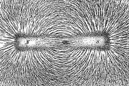 Magnet attracting iron filings