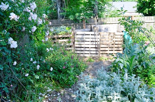 Our three bin compost system tucked into the back corner of the garden