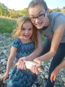 Big sister Nessy poses with Lily's catch on an earlier fishing trip this year. 