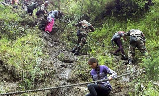 Army soldiers rescuing pilgrims during their flood relief operation in Chamoli, Uttarakhand