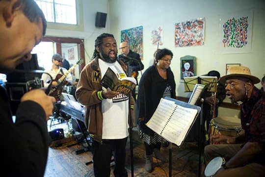 Lloyd G Francis reads from his debut novel From Rum To Roots, while the jazz band plays Duke Ellington.