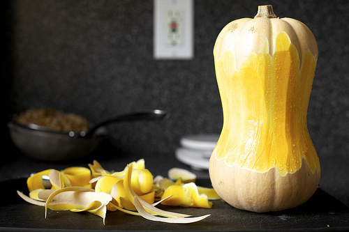 peeling the squash, which looks like a peanut