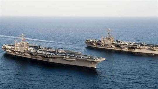 The Nimitz-class aircraft carriers USS John C. Stennis (R) and USS Abraham Lincoln transit during a turnover of responsibility in the Arabian Sea. (REUTERS)