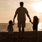 dad with kids on beach