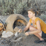 Rivera Sun preparing her hand built wood fired oven for baking.