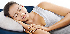 sleeping woman on pillow in grey tank top