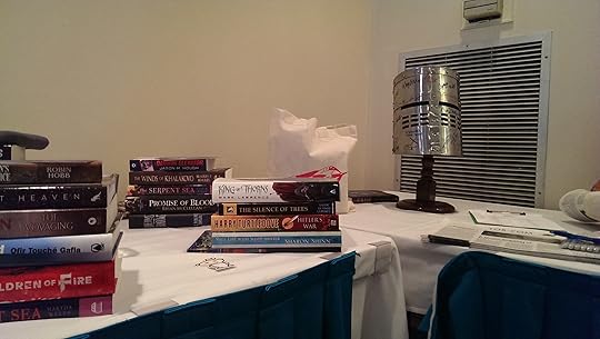 Books and Helm at the party, piled into lots to be given away, along with some bonus Tor goodies.