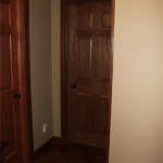 Trimmed hallway doors; note slight color difference between bathroom door and office door -- we had originally intended to go with the bathroom color until I realized how much I HATE STAINING DOORS.