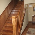 Staircase with skirtboard and wainscot; the light adds to the Arts and Crafts style of the wood