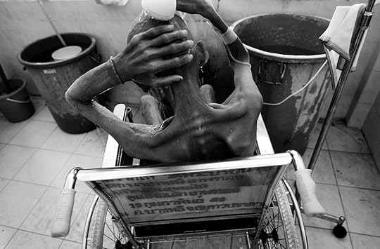 Sopchai takes his daily shower on Wednesday, March 8, 2006 at Wat Prabat Nampu, in Lopburi, Thailand. Two or three patients at a time are bathed on a daily basis by the nurses and volunteers. The temple hospice has limited resources, but the staff, volunteers, and patients do the best with what they have. (Photo by Matthew Williams/ZUMA Press)
