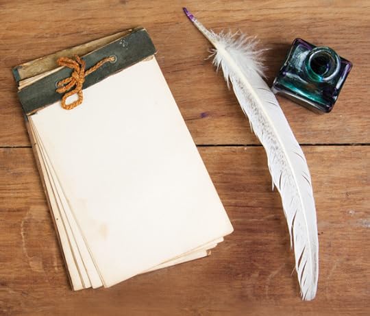 Quill ink pen and inkwell, old notepad on wood table