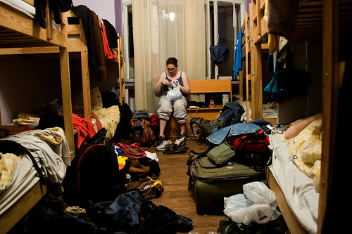 A girl in a hostel dorm room.