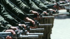 Marching soldiers with raised weapons