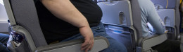 very big obese person traveling by airplane