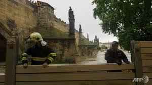 Workers install new flood protection walls along the Charles Bridge.