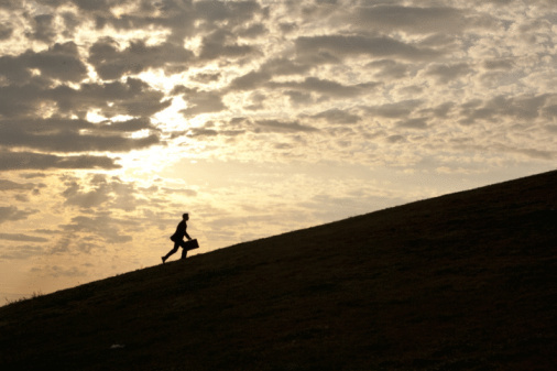 business man walking up hill