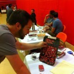Mike Mehalek plays with the Fridge of the Damned poetry magnet display at the book signing.