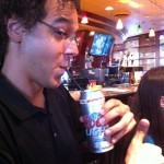 John Edward Lawson from RDS Press samples an odd beer can cocktail through a straw.