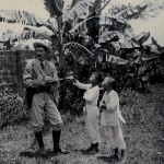 Local boys watching a war artist sketch in the field.