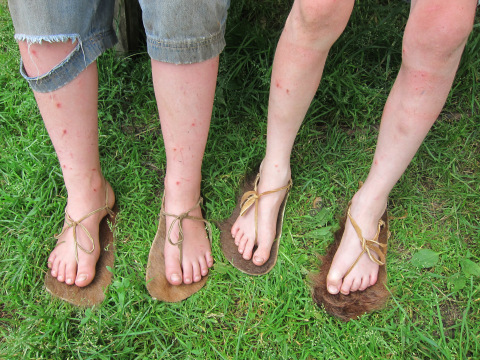 The boys made sandals with Nate. Materials: Rawhide and the coat of Scottish Highland cattle