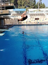 Bethany practices a front flip off the platform while training at UCLA's pool.