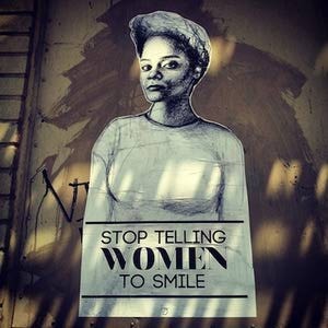 poster image of a woman staring back at the viewer with text under "stop telling women to smile"