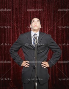 depositphotos_13221809-Young-man-speaking-into-a-microphone[2]