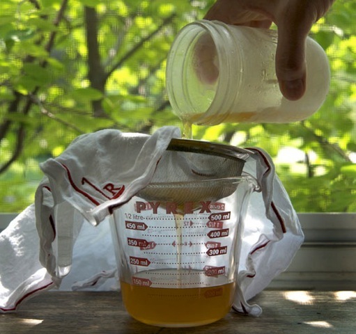After a three day infusion, I froze the fat, removed it, then strained the whiskey through a straining cloth to catch remaining fat globules. Photo by Donna.
